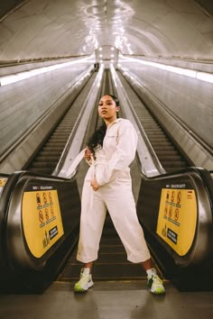 a woman standing on an escalator at the airport