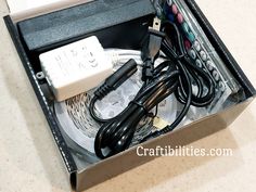 an open box with wires and cords in it