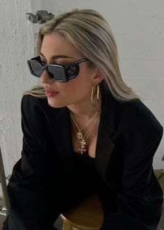 Elevate your wardrobe with timeless staples. The layered gold necklaces and bold hoops radiate sophistication, perfectly paired with sleek shades and a classic black blazer. Each ÖUGIE piece is crafted from 14k solid gold, designed to last a lifetime.  #TimelessStyle #MinimalLuxury #14kGold #EverydayChic #GoldAccessories #EffortlesslyElegant #JewelryGoals #SustainableStyle Layered Gold Necklaces, Timeless Staples, Everyday Chic, Gold Necklaces, Gold Necklace Layered, Gold Accessories, Black Blazer, Ear Jewelry, Classic Black