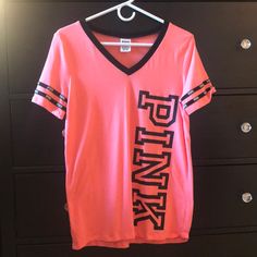 *Coral Pink Color Sporty Pink T-shirt With Logo Print, Pink V-neck T-shirt With Letter Print, Pink V-neck Athleisure Top, Pink V-neck Graphic Tee Top, Pink V-neck Graphic Tee, Pink Sports T-shirt With Graphic Print, Trendy Pink V-neck T-shirt, Sporty Pink Crew Neck T-shirt, Pink V-neck Sports Top