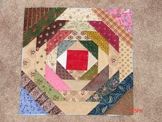 a close up of a patchwork quilt on the floor