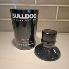 a coffee cup sitting on top of a counter next to a shaker shaped like a dog