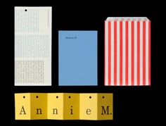 an open book and several pieces of paper with the word annie m on them, next to each other