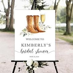 a welcome sign with boots and flowers on it