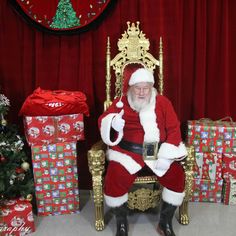 a man dressed as santa claus sitting on a golden chair