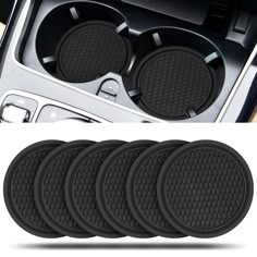 four black car coasters with the center console cover removed and in front of it