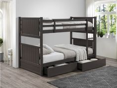 a bunk bed with drawers underneath it in a room that has hardwood floors and white walls