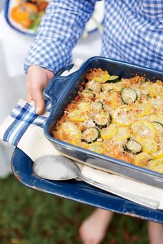 a close up of a person holding a tray of food