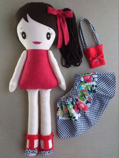 a doll and accessories laid out on a table