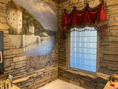 a bathroom with a large mural on the wall and a tub in front of it