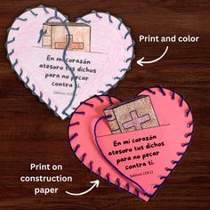 two heart shaped paper pieces with words written in spanish and english on them, next to each other