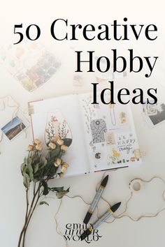 an open book sitting on top of a table next to some flowers and other items