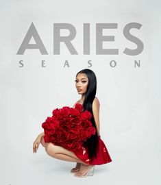 a woman in a red dress with flowers on her knee and the words aries season