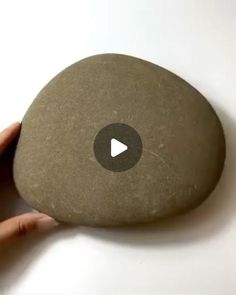 a person holding a rock with a video on it