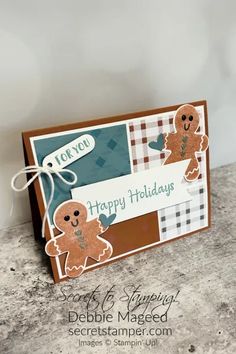 a close up of a greeting card with a ginger on the front, and a happy holidays message on the back