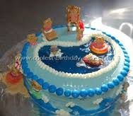 a blue and white birthday cake with teddy bears on top