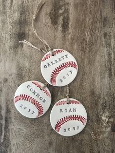 three baseball ornament hanging on a wooden table