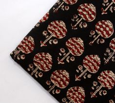 a black tie with red and white skulls on it's side, in front of a white background