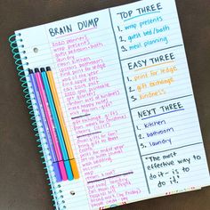 a notebook with writing on it and some colored pencils next to it that says brain dump