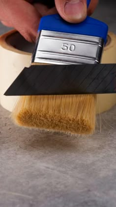 a person is using a brush to clean the floor