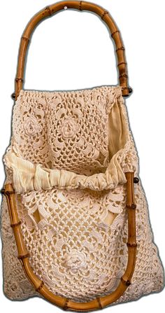 a crocheted purse with a wooden handle