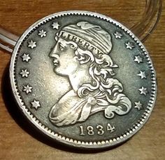 a silver coin sitting on top of a wooden table