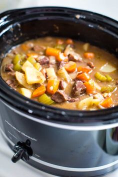 a crock pot filled with meat and vegetables