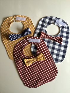 three bibs with different patterns and designs on them