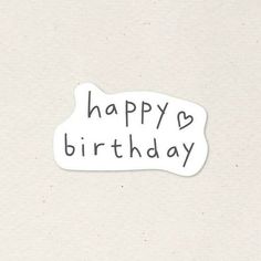 a white sticker with the words happy birthday written in black ink on top of it