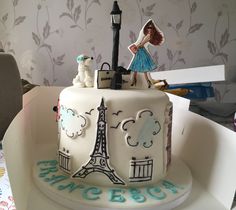 a white cake decorated with the eiffel tower