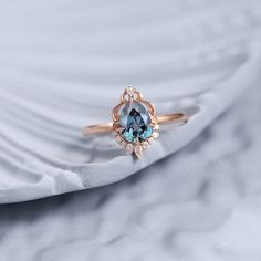 an engagement ring with a blue topazte surrounded by diamonds