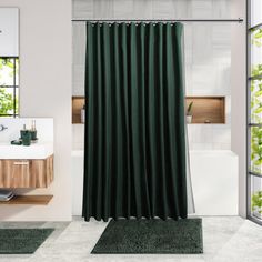 a green shower curtain in a bathroom next to a sink