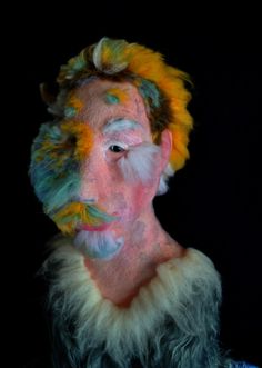 a man with multicolored hair and beard is shown in this artistic portrait photo