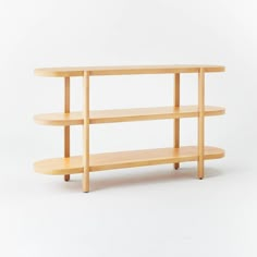 a wooden shelf sitting on top of a white wall