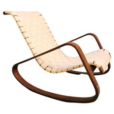 a wooden rocking chair with white fabric on it