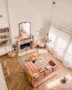 an aerial view of a living room with pink furniture