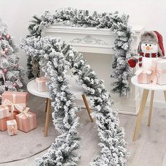 christmas decorations and presents in front of a fireplace