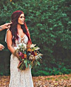 the bride is getting ready to walk down the aisle with her groom and flower bouquet