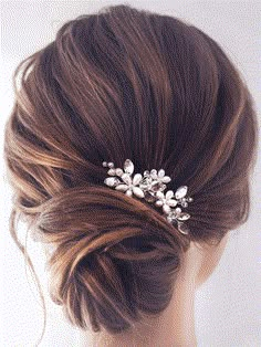 a woman wearing a hair comb with flowers in it