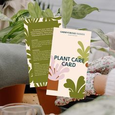 a plant care card sitting on top of a table next to some potted plants