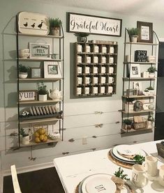 a kitchen with white cabinets and shelves filled with dishes