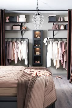 a bedroom with closets and clothes hanging on the wall next to it's bed