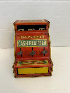 an old fashioned cash register sitting on a white counter top with the words happyday's cash register