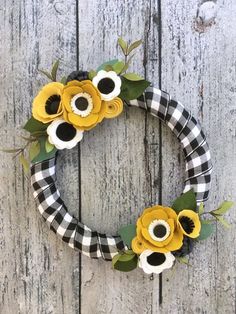 a black and white wreath with yellow flowers