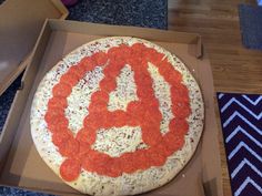 a pizza in a box with the letter a on it