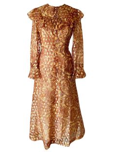 "LATE 1960S OSCAR DE LA RENTA BOUTIQUE GOLD METALLIC DRESS Incredible collector's piece - vintage early Oscar de la Renta gold metallic dress. This dress dates to when Oscar de la Renta began designing ready to wear under his own name - in the late 60s. Made of a stunning gold metallic organza paisley printed fabric, this dress features a beautiful ruffled bib detail and fabric covered buttons on the bodice. Full length, this dress has a slight flare at the hem which accentuates the body perfect Vintage Gold Long Sleeve Dress, Festive Vintage Gold Dress, Vintage Gold Evening Dress, Vintage Gold Dress For Evening, Vintage Gold Dresses For Evening, Festive Vintage Dresses For Vintage Events, Vintage Gold Dress For Vintage Events, Vintage Fitted Gold Dress, Fitted Vintage Gold Dress