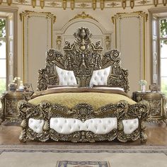 an ornately decorated bedroom with gold and white decor, including a king size bed