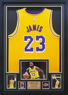 a basketball jersey with the number 23 on it is framed in black and gold frame