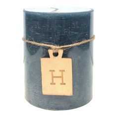 a blue candle with a wooden tag on it