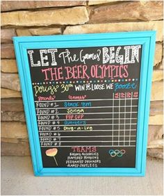 a chalkboard sign on the side of a stone wall that says let the games begin